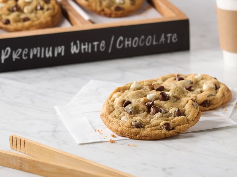 two chocolate chip cookies on a napkin