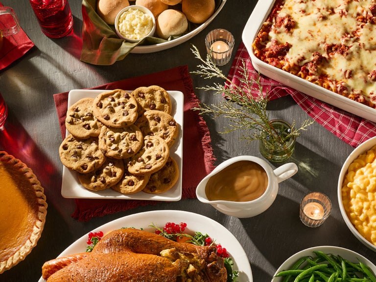 table set with turkey chocolate chip cookies pie and macaroni and cheese