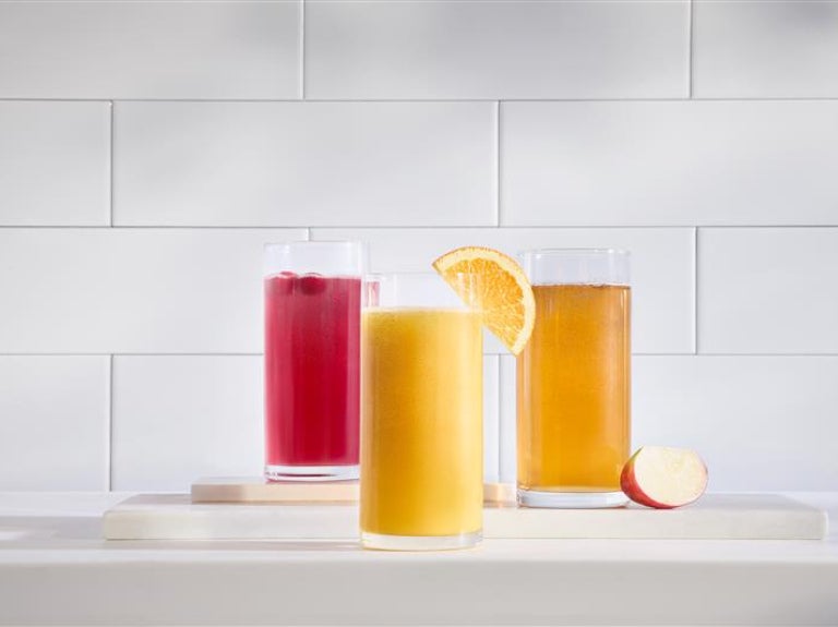 Vitality express beverages on white counter with white tile background