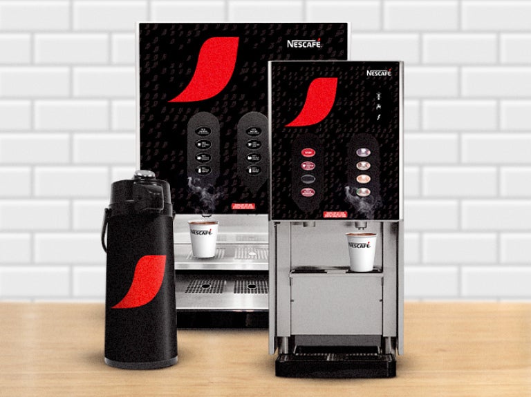 Nescafé coffee machines in two sizes, with a branded airpot beside them. Perfect for office break rooms or any workplace