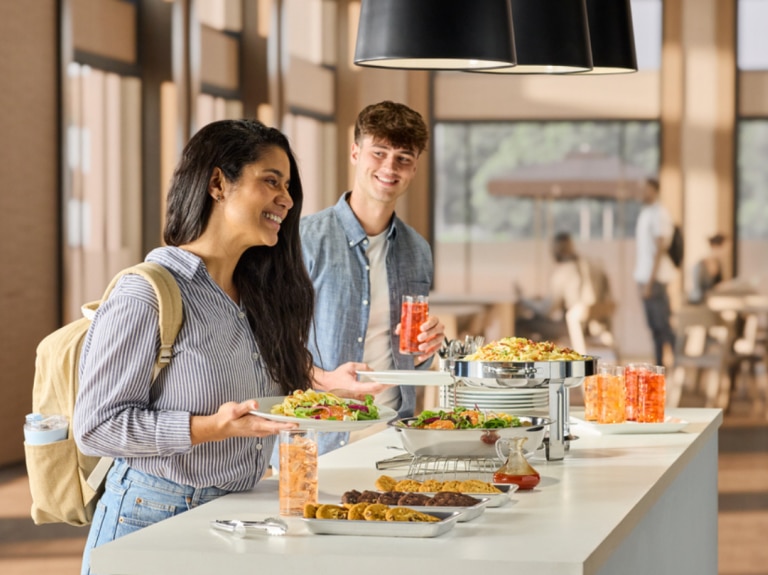woman and man getting food at counter