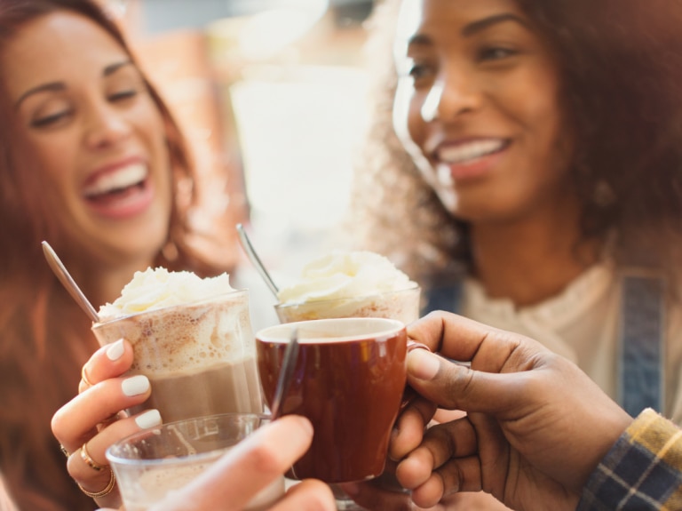 coffee culture trend report two women with coffee in hand