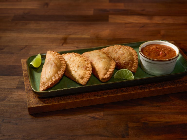 empanadas on wood serving board