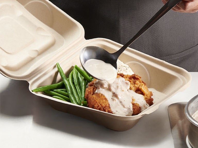 stouffers white gravy pouring over poultry in a to go box