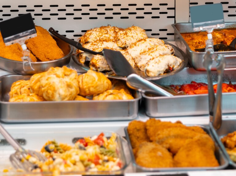 vrepared sandwiches, wraps, and other grab-and-go foods displayed in a refrigerated deli case.