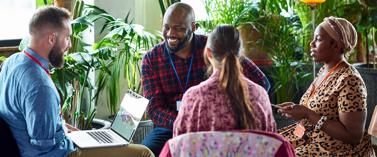 People gathered around a table with laptop