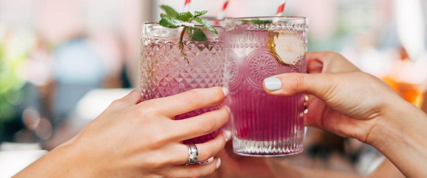 hands holding drinks in celebration
