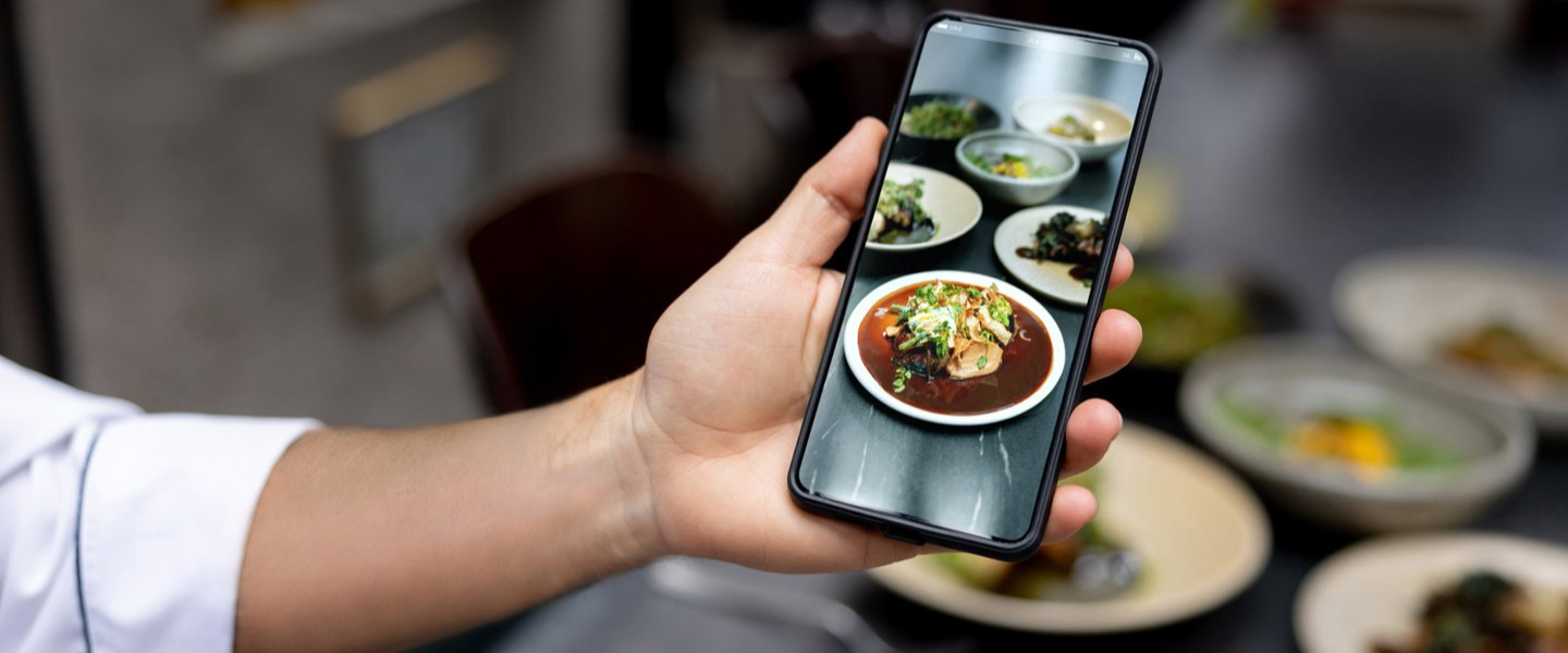 Sustainability person holding cell phone with image of food