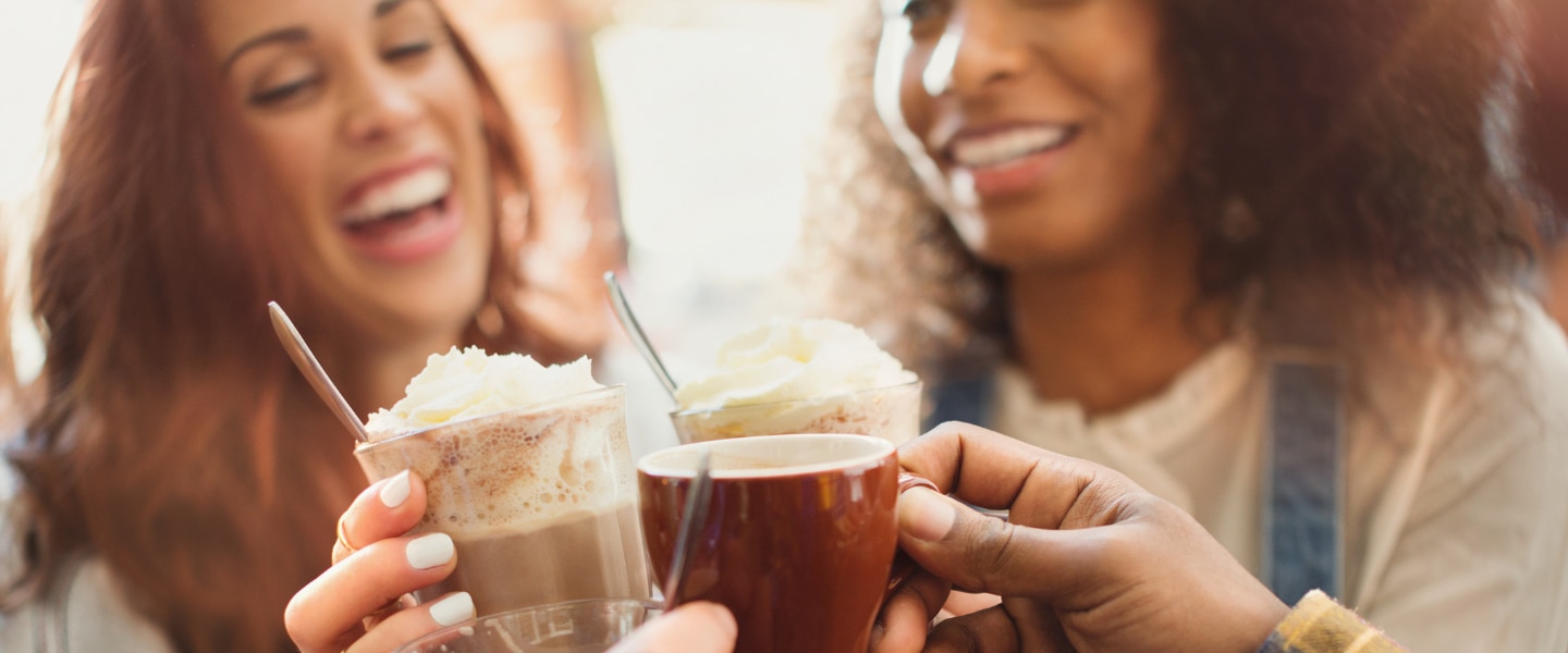 coffee culture trend report two women with coffee in hand