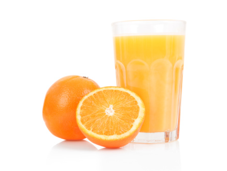 sliced orange with glass of orange juice