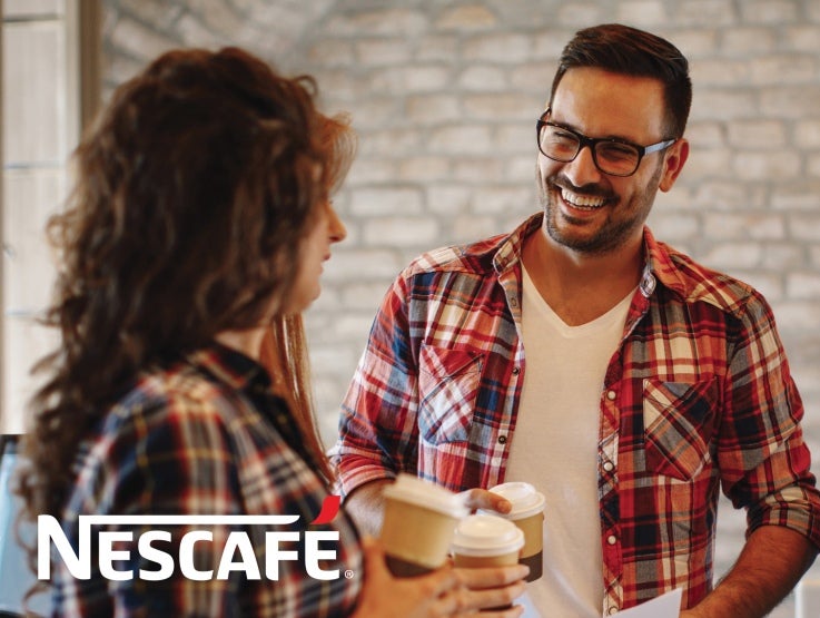 Nescafe man and woman with coffee in hand talkiing