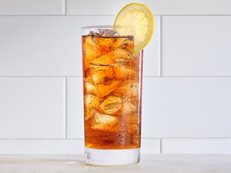 Nestea iced tea in a clear glass with lemon