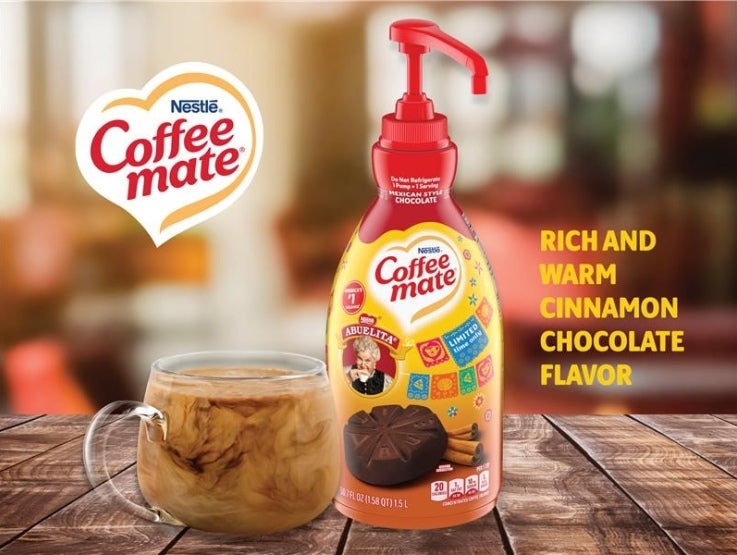 coffee mate abuelita pump bottle with cup of coffee on table