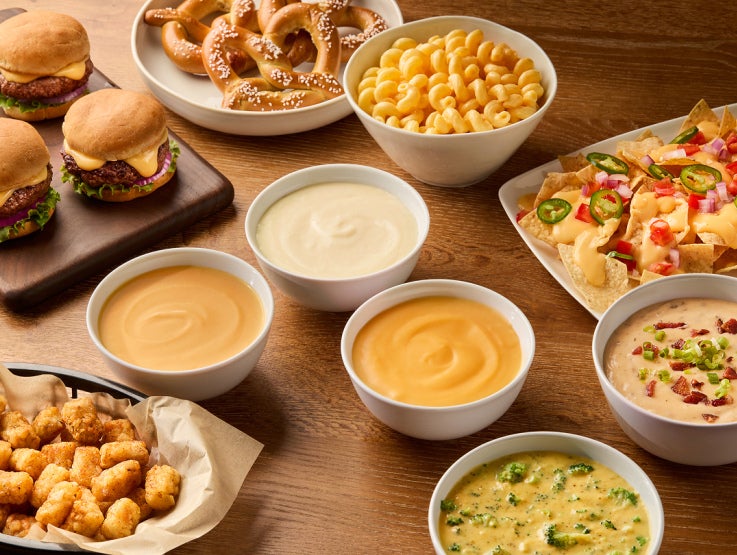A table full of sauces, dips and burgers