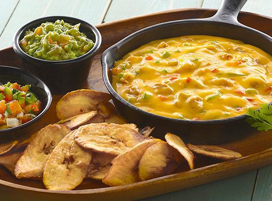 Queso Fundido with Plantain Chips with Trio Cheese Sauce
