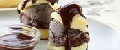 Plate of profiteroles with side of chocolate sauce