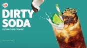 Image of a coffee mate dirty soda ad, displaying a refreshing drink in a glass with ice and a lime slice.