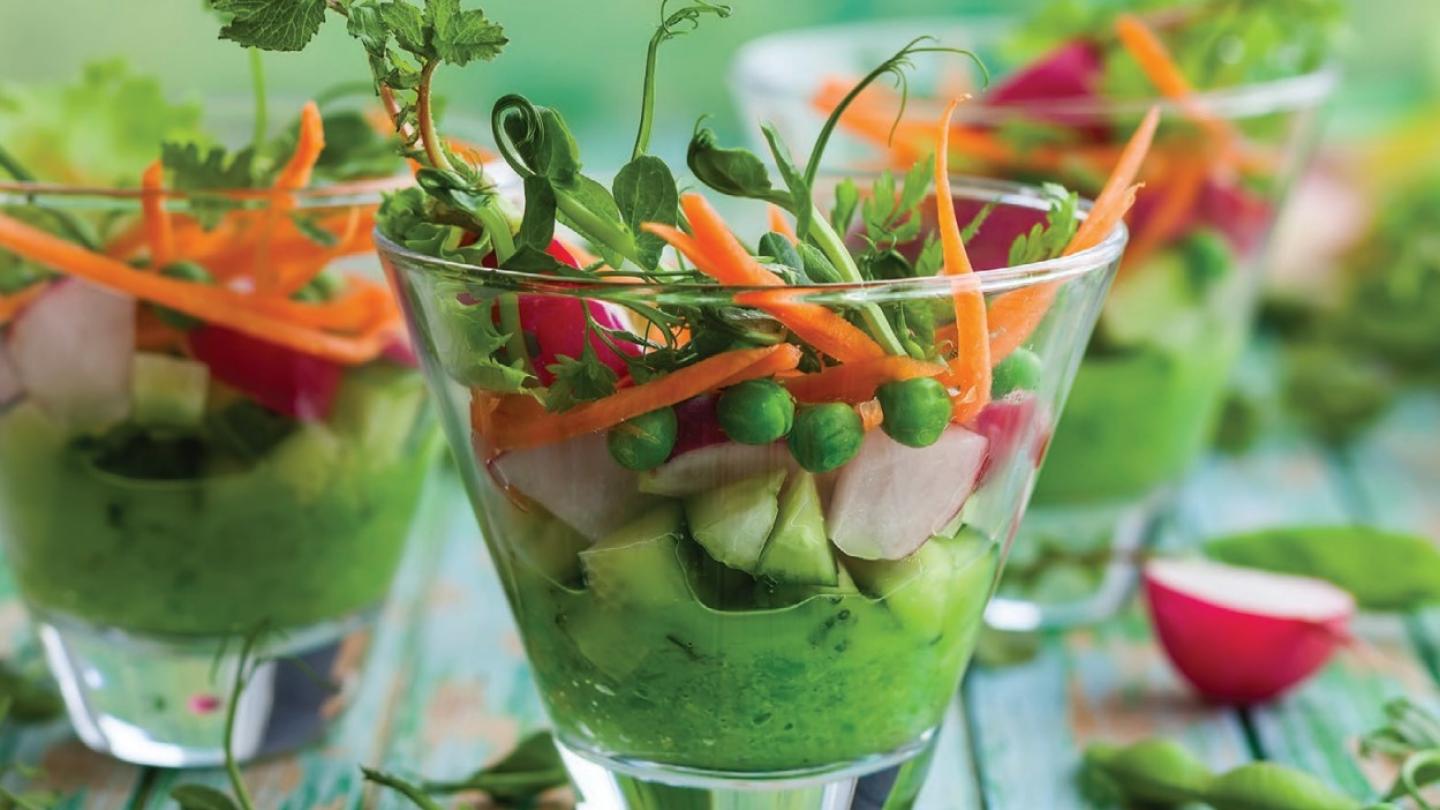 Guacamole, cucumbers, radishes, and carrots in elegant glass cups