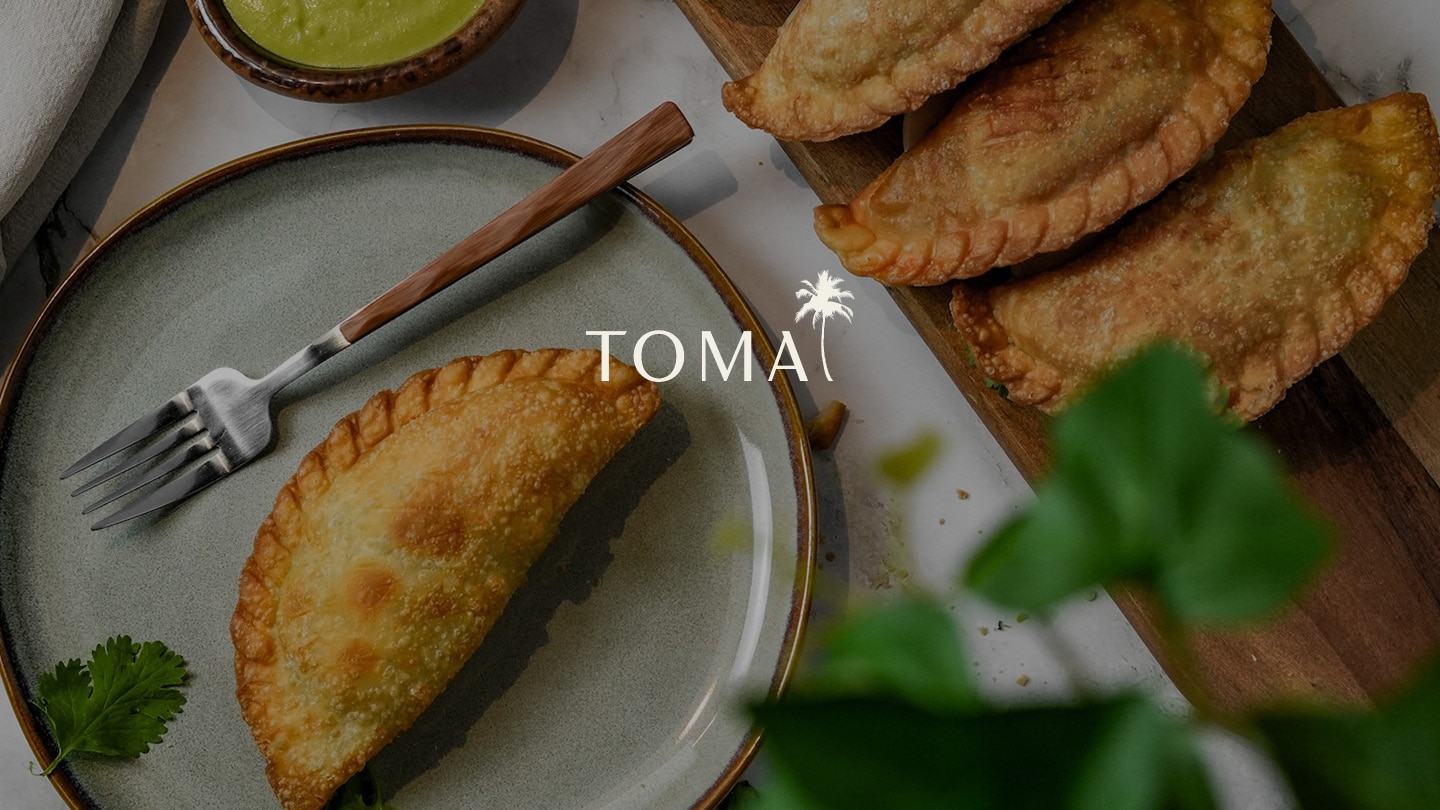 Toma empandas on plate with fork