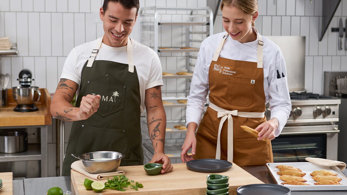 chefs in kitchen preparing a meal