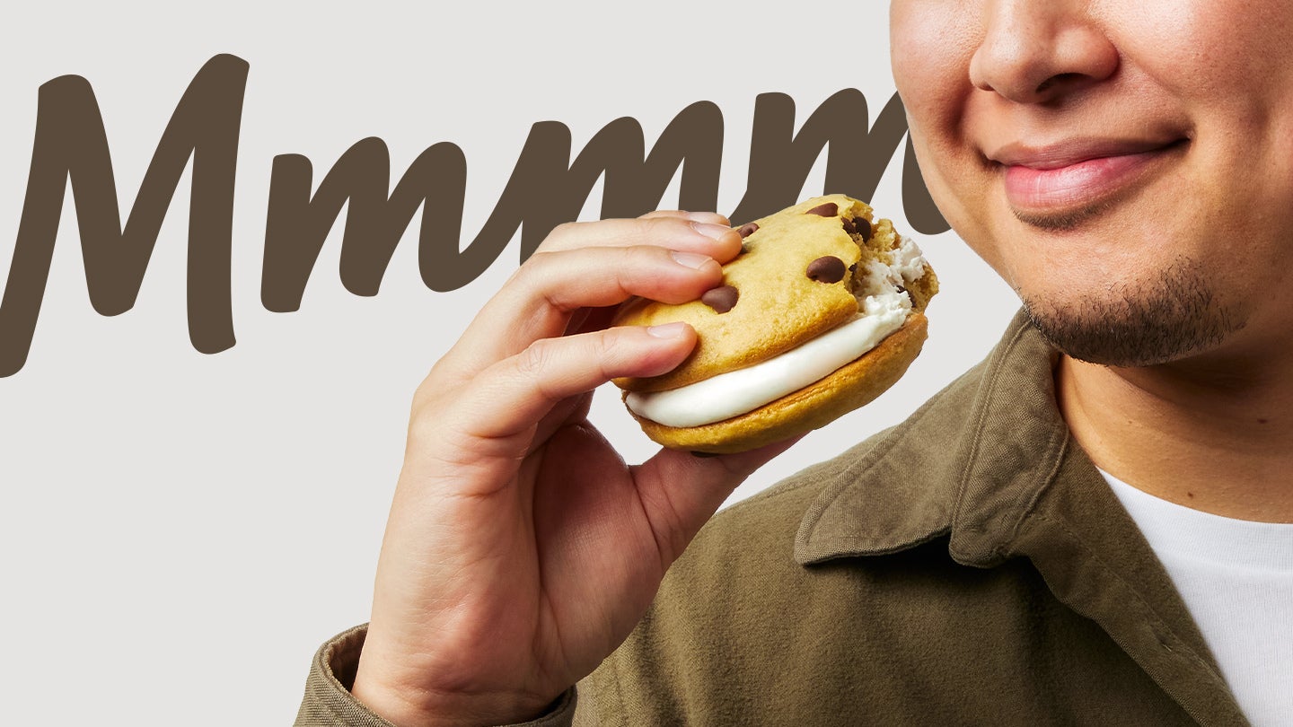 man holding chocolate chip whoopie pie in hand