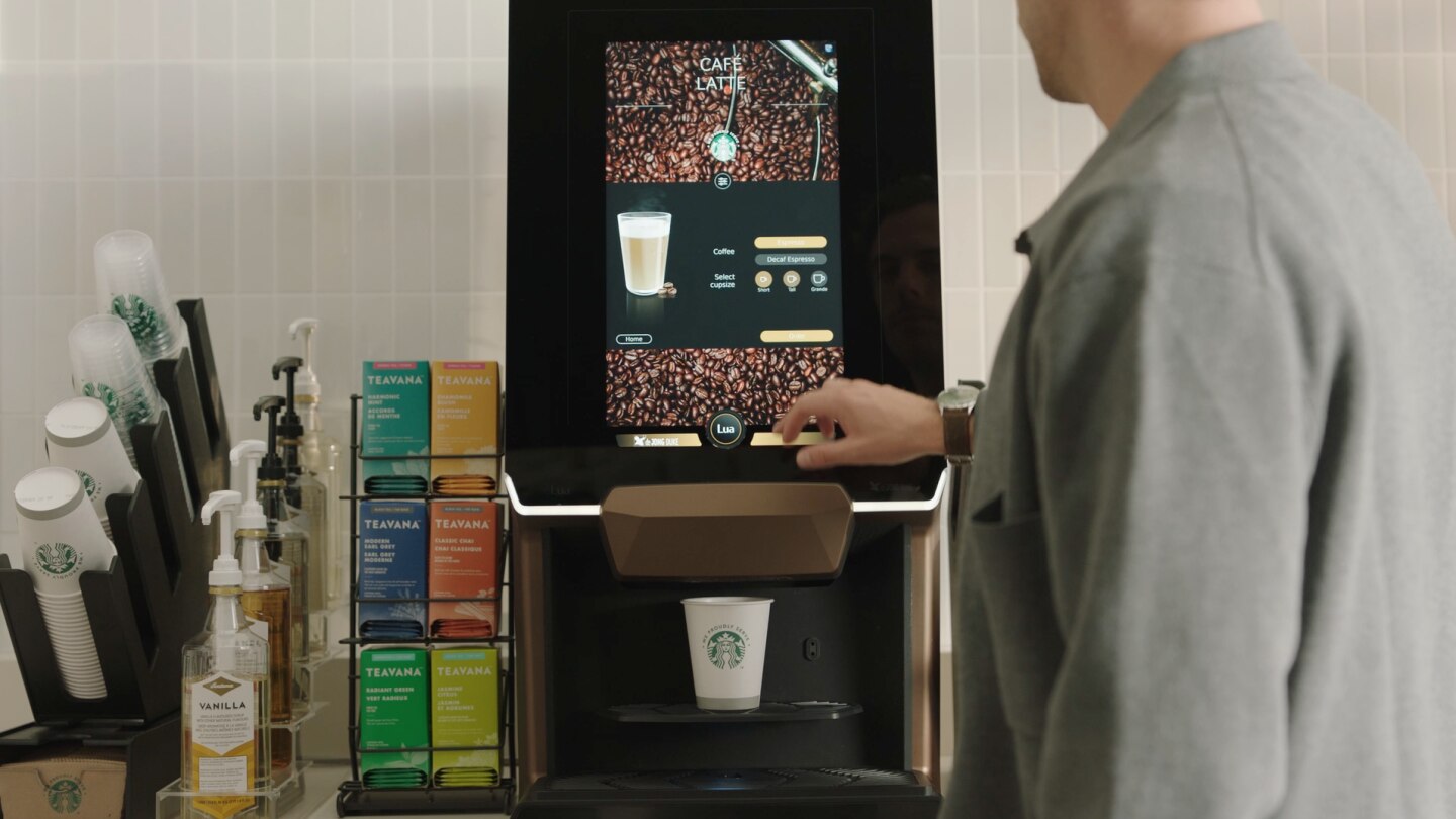 man using starbucks coffee machine